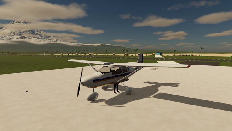 Light aircraft parked on an island airstrip, palms and mountains in the distance